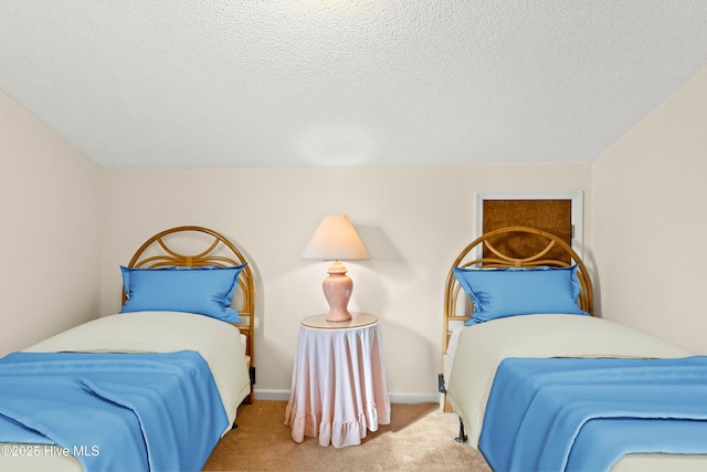 carpeted bedroom featuring baseboards, a textured ceiling, and vaulted ceiling