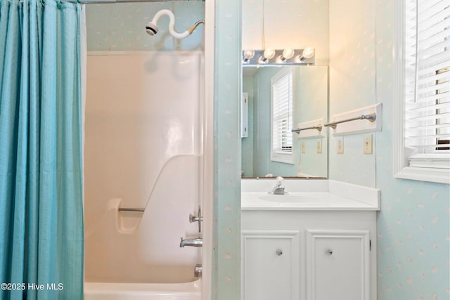 full bath with vanity, shower / tub combo, and wallpapered walls