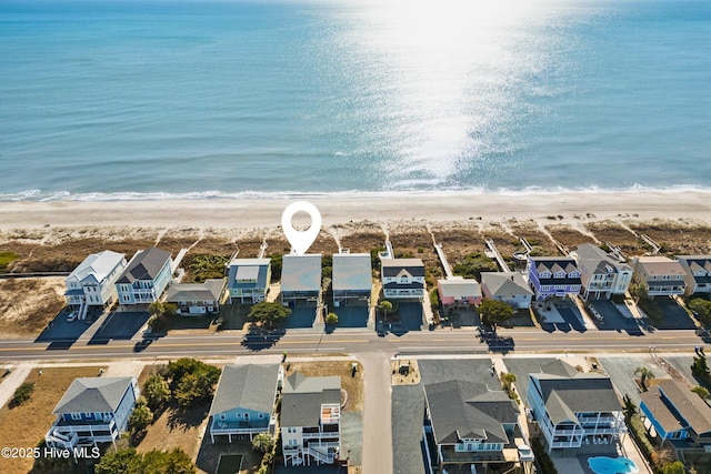 drone / aerial view with a view of the beach, a residential view, and a water view