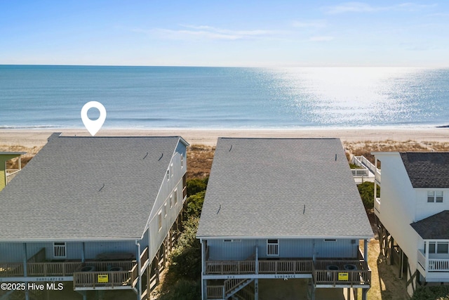 birds eye view of property with a beach view and a water view