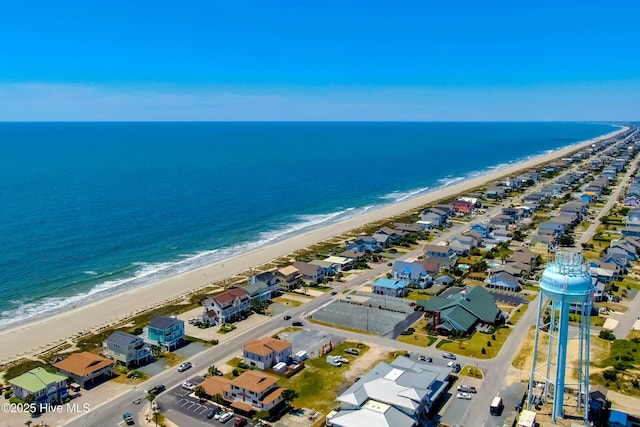 birds eye view of property with a beach view and a water view