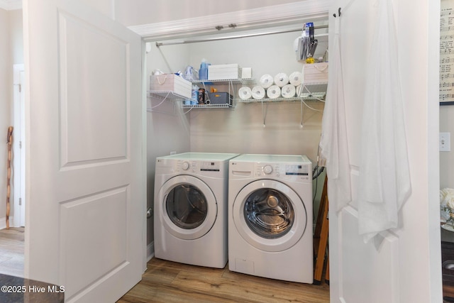 laundry area with washer and dryer, laundry area, and wood finished floors