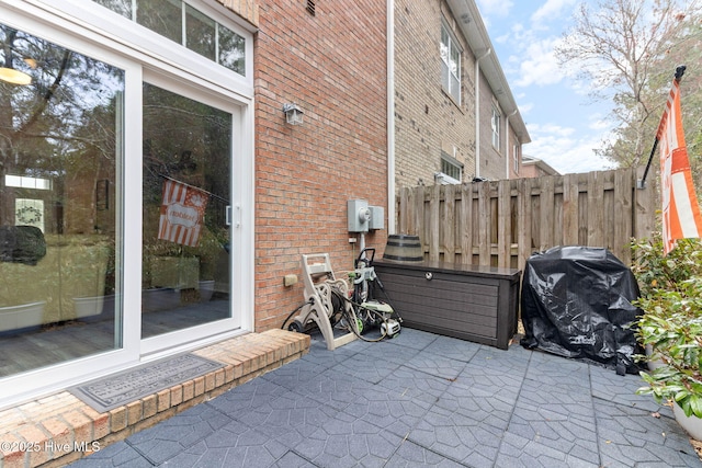 view of patio with grilling area and fence