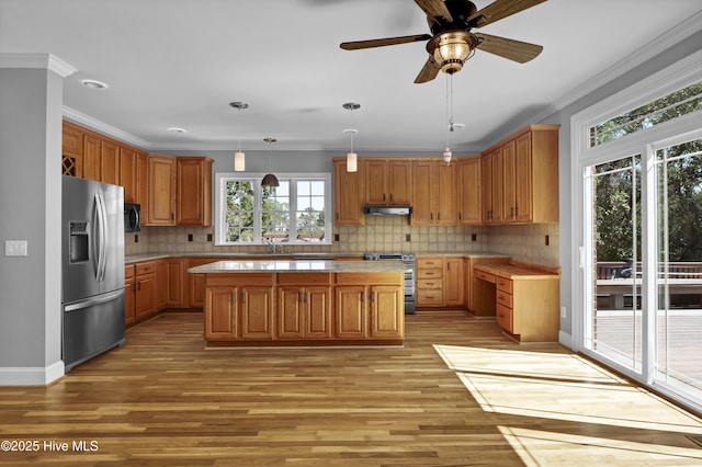 kitchen featuring crown molding, light countertops, and appliances with stainless steel finishes