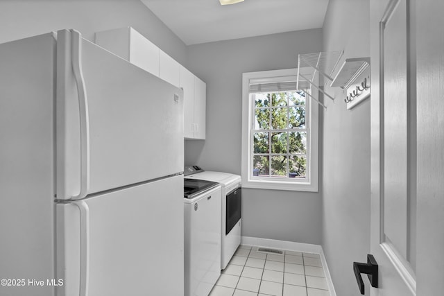 laundry area featuring visible vents, washer and dryer, cabinet space, light tile patterned floors, and baseboards