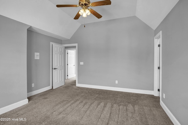 empty room with vaulted ceiling, carpet flooring, and baseboards