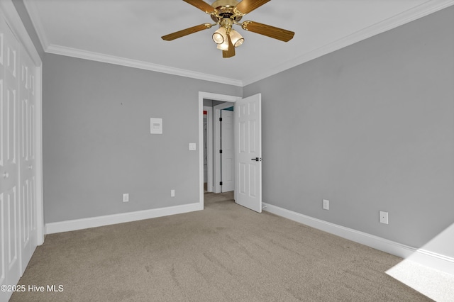 unfurnished bedroom featuring baseboards, carpet floors, and ornamental molding