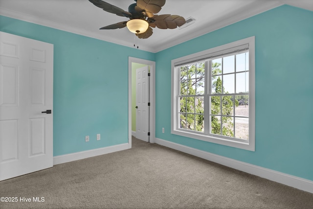 unfurnished bedroom featuring carpet flooring, baseboards, and ornamental molding