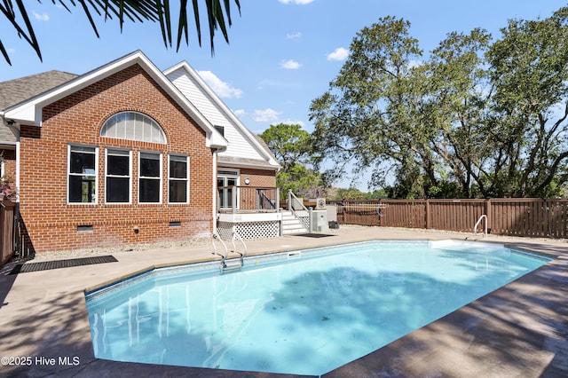 view of swimming pool with a patio area, a fenced in pool, a deck, and fence