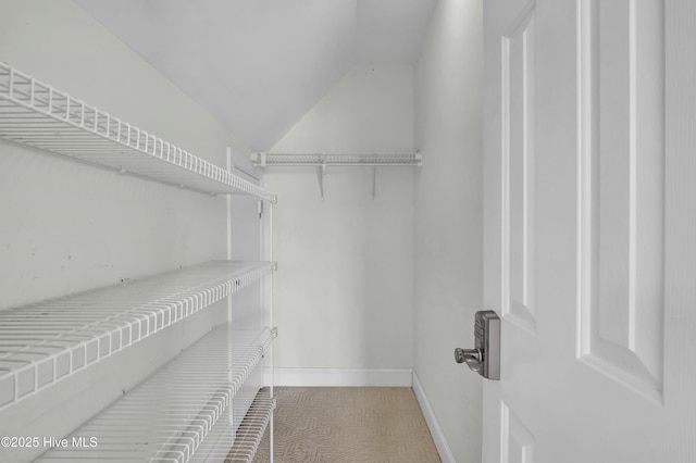 spacious closet featuring vaulted ceiling