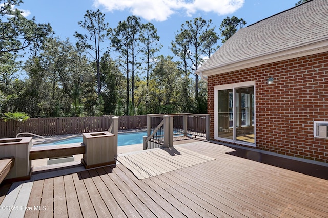 wooden terrace featuring a fenced in pool, a hot tub, and fence