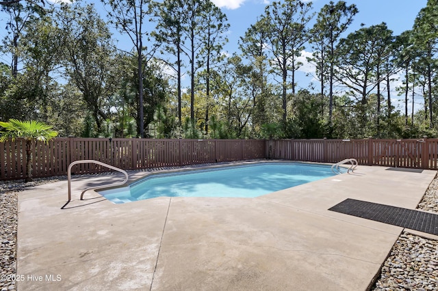 view of pool featuring a patio, a fenced backyard, and a fenced in pool