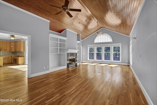 unfurnished living room featuring high vaulted ceiling, light wood-style flooring, a tiled fireplace, baseboards, and wood ceiling