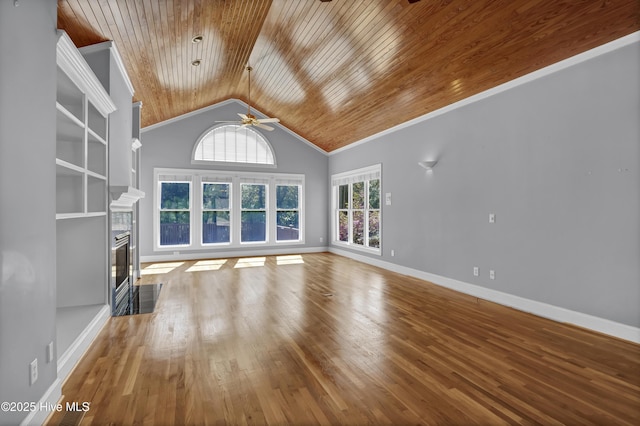 unfurnished living room featuring a tiled fireplace, wooden ceiling, baseboards, and wood finished floors