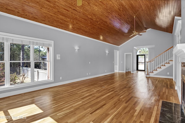 unfurnished living room with stairway, wood finished floors, baseboards, a fireplace, and wood ceiling