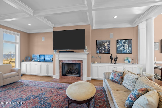 living area with beam ceiling, decorative columns, and coffered ceiling