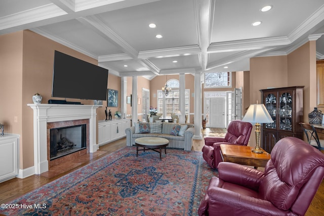 living area with coffered ceiling, ornate columns, recessed lighting, a high end fireplace, and beamed ceiling