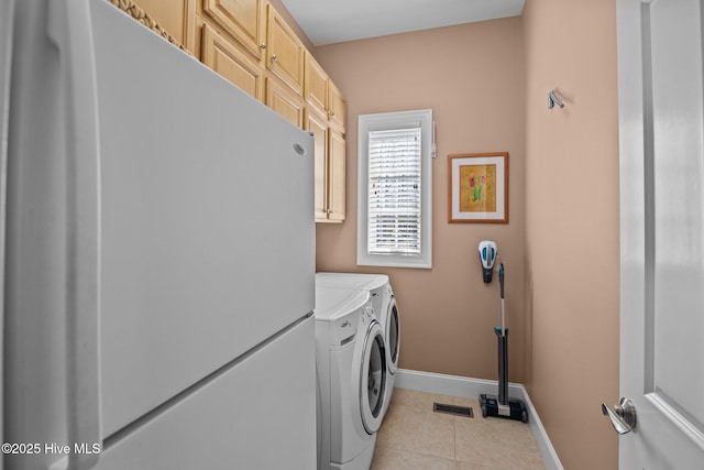 laundry area with washing machine and clothes dryer, visible vents, baseboards, light tile patterned floors, and cabinet space