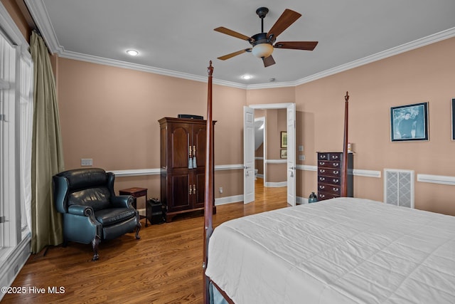 bedroom with crown molding, recessed lighting, wood finished floors, and visible vents