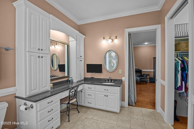 bathroom featuring vanity, tile patterned floors, toilet, and ornamental molding