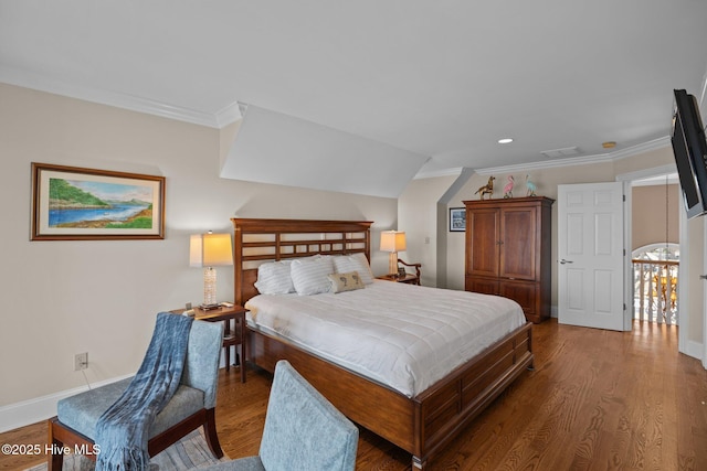 bedroom with crown molding, wood finished floors, baseboards, and visible vents