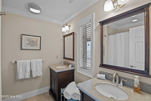 bathroom featuring tile patterned floors, two vanities, crown molding, and a sink