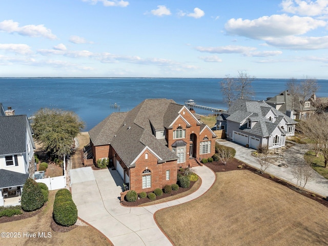 bird's eye view with a water view and a residential view