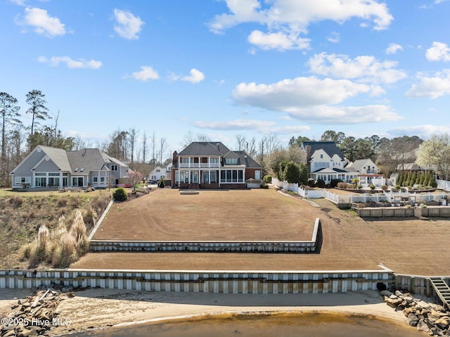 back of property featuring a residential view