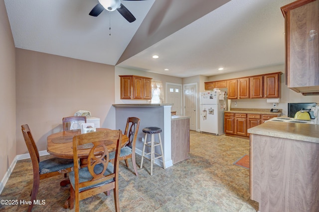 dining space featuring recessed lighting, baseboards, a ceiling fan, and vaulted ceiling