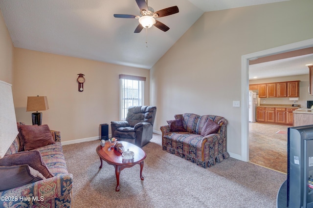 living room featuring baseboards, light carpet, high vaulted ceiling, and ceiling fan