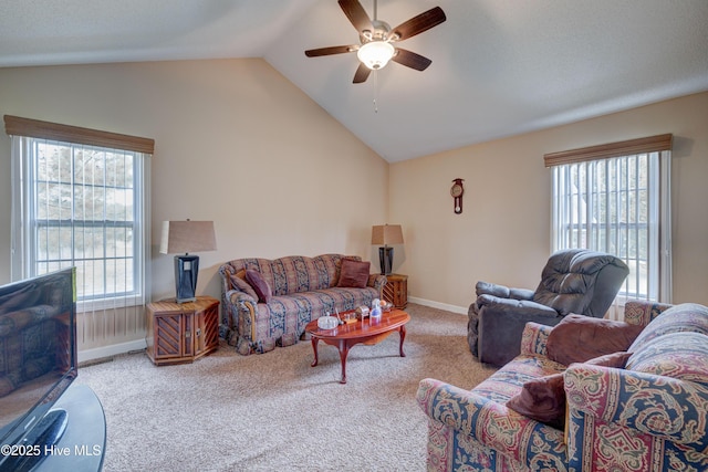 carpeted living room featuring baseboards, ceiling fan, and vaulted ceiling