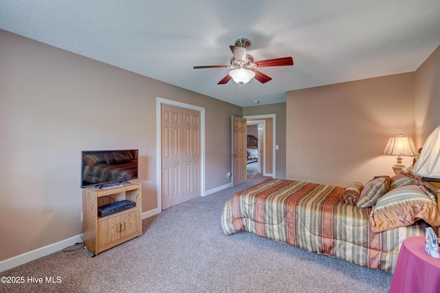 bedroom featuring baseboards, carpet floors, and a textured ceiling