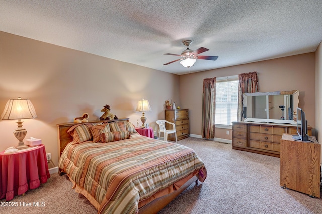 bedroom featuring a textured ceiling, a ceiling fan, baseboards, and light carpet