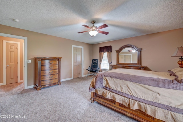 carpeted bedroom with baseboards, a textured ceiling, and a ceiling fan