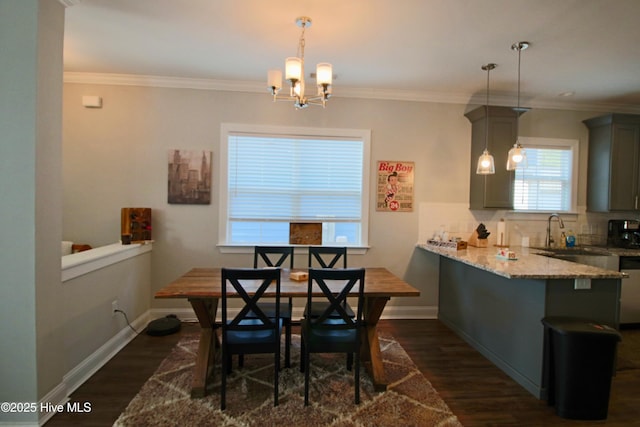 dining area with dark wood-type flooring, crown molding, and baseboards