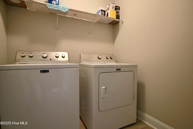 washroom featuring laundry area, independent washer and dryer, and baseboards