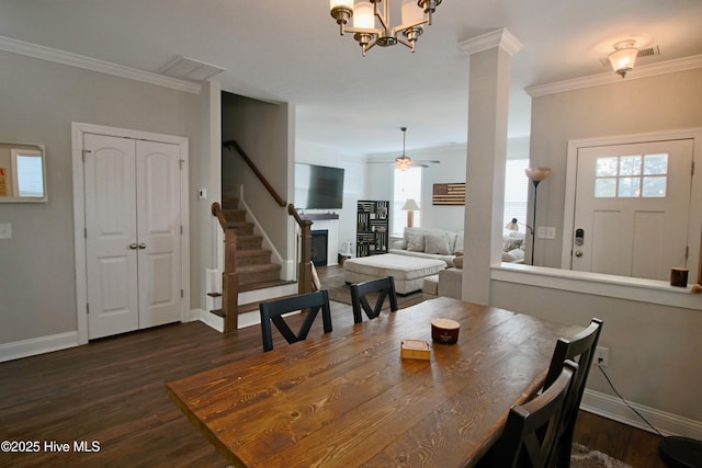 dining area featuring dark wood finished floors, crown molding, stairs, and baseboards