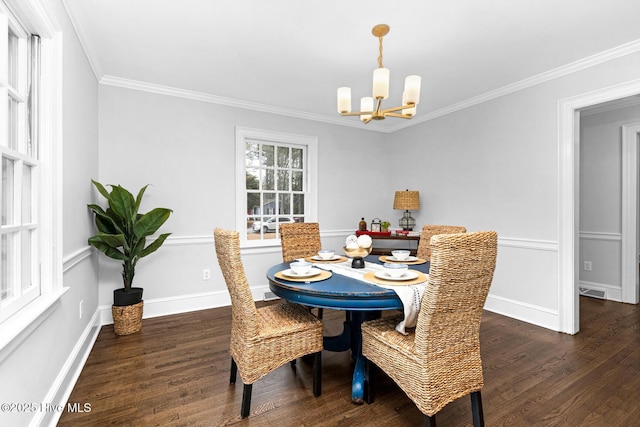 dining area featuring visible vents, ornamental molding, wood finished floors, baseboards, and a chandelier