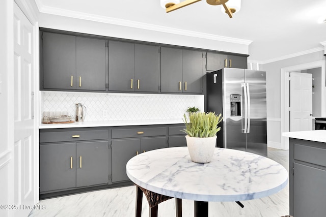 kitchen featuring marble finish floor, gray cabinetry, stainless steel refrigerator with ice dispenser, and crown molding