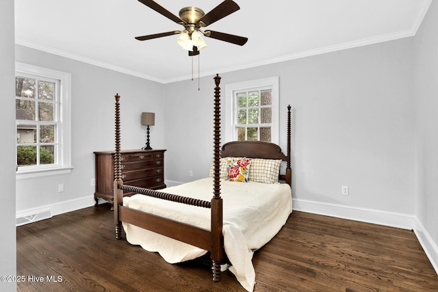 bedroom featuring visible vents, baseboards, wood finished floors, and ornamental molding