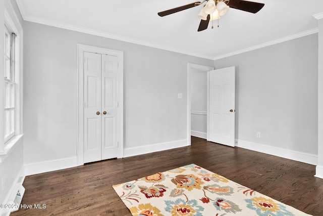 unfurnished bedroom with baseboards, dark wood-type flooring, and ornamental molding