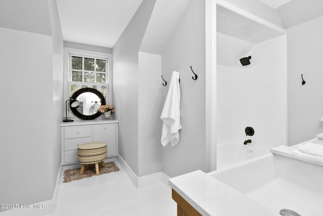 full bathroom with baseboards, bathtub / shower combination, and vanity