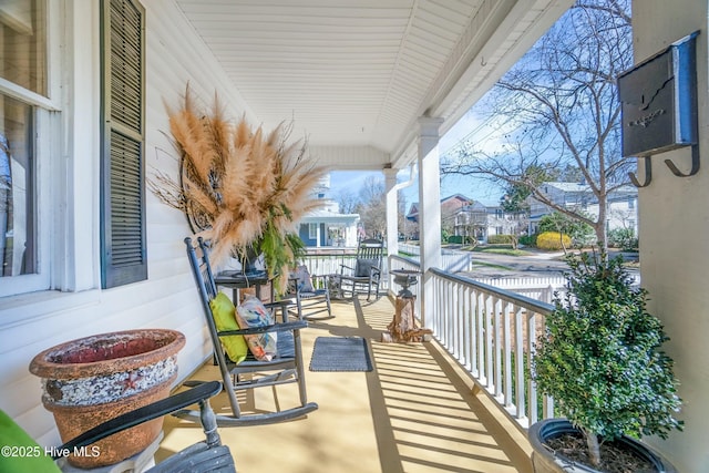 balcony featuring a residential view and covered porch