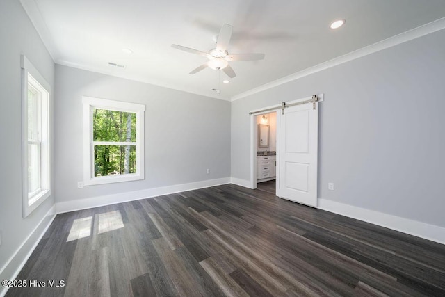 485 N Wild Rice Dr SW, Supply, NC 28462 - unfurnished bedroom featuring baseboards, dark wood-style floors, and a barn door