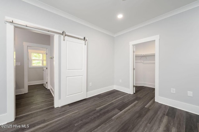 485 N Wild Rice Dr SW, Supply, NC 28462 - unfurnished bedroom with baseboards, dark wood finished floors, a barn door, and ornamental molding
