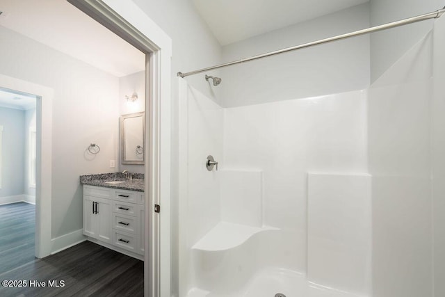 485 N Wild Rice Dr SW, Supply, NC 28462 - bathroom featuring a shower, baseboards, vanity, and wood finished floors