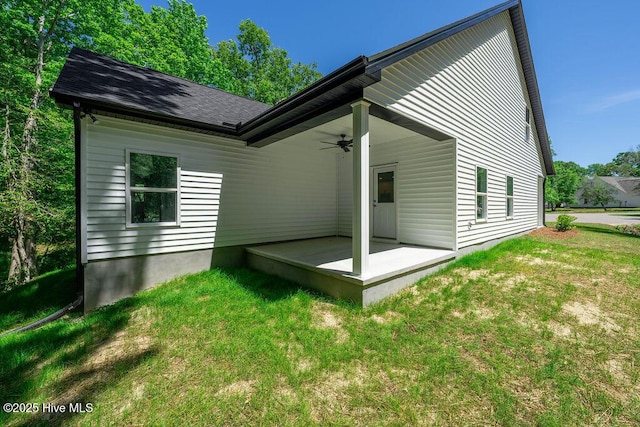 485 N Wild Rice Dr SW, Supply, NC 28462 - rear view of house featuring a lawn, roof with shingles, ceiling fan, and a patio area