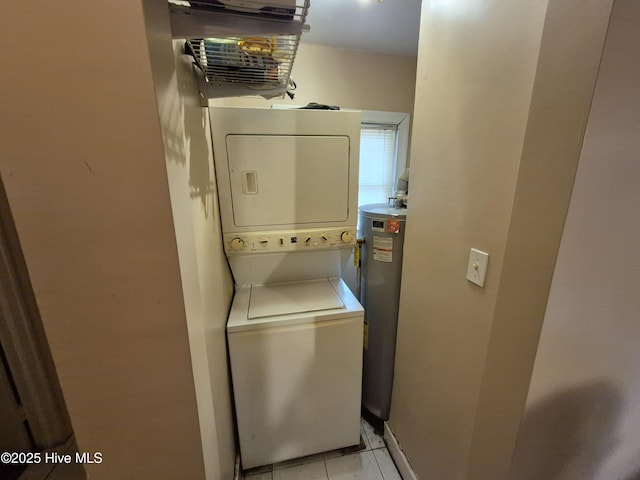 laundry room with water heater, laundry area, stacked washing maching and dryer, and light tile patterned floors