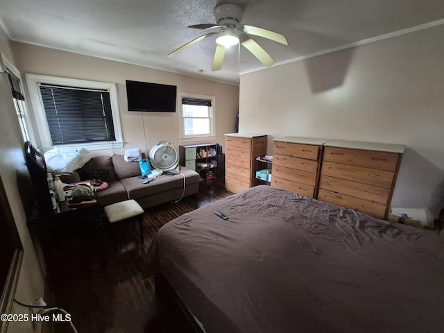 bedroom featuring ceiling fan, crown molding, and hardwood / wood-style flooring