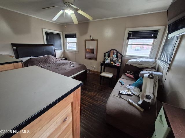 bedroom with ornamental molding, ceiling fan, and dark wood-style flooring